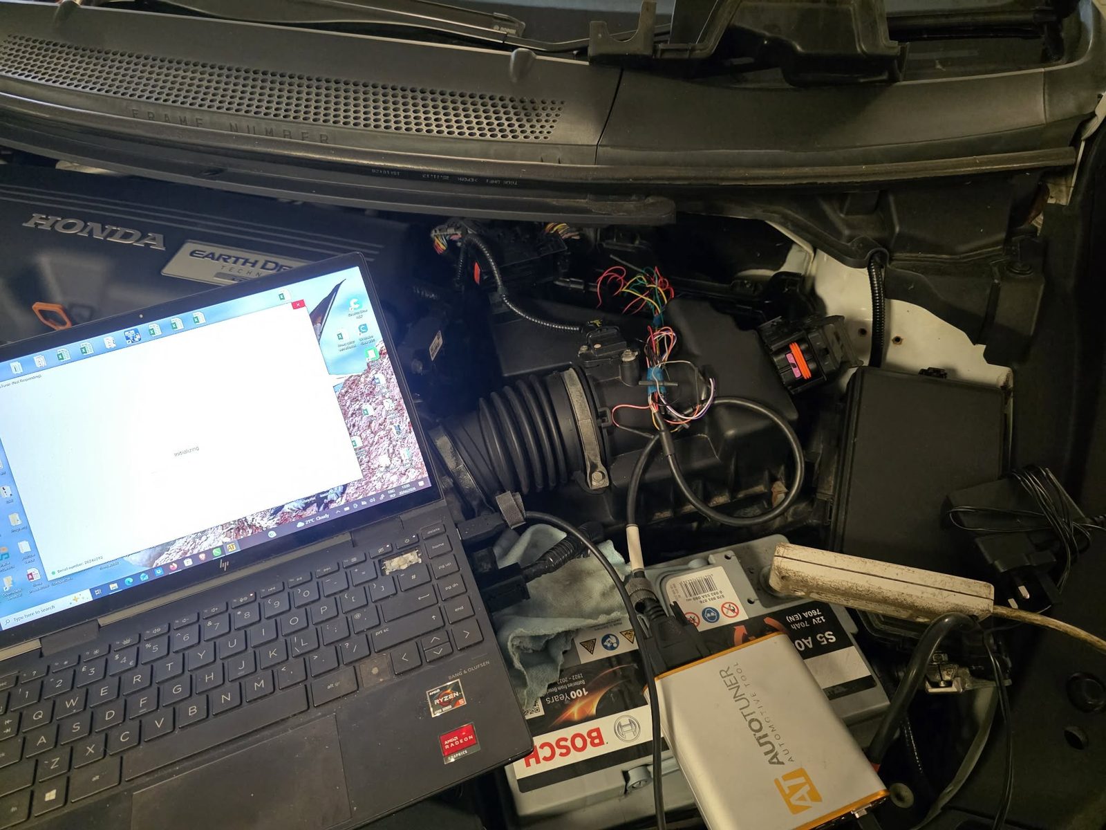 Laptop and interface plugged into a Honda engine bay for an ECU remap